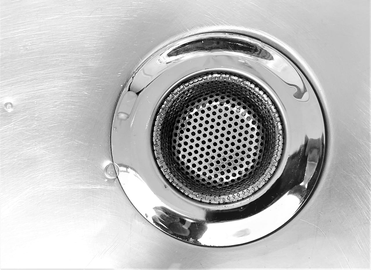 Metal strainer and kitchen sink drain